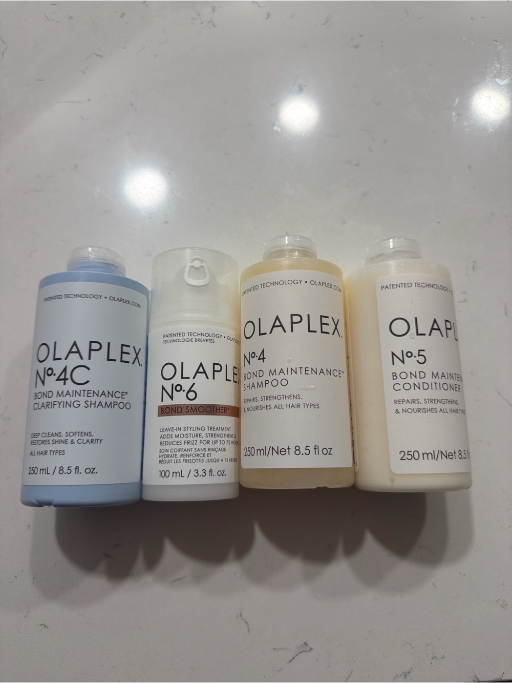 OLAPLEX Travel Bond Care Set — Light Blue, White, Cream